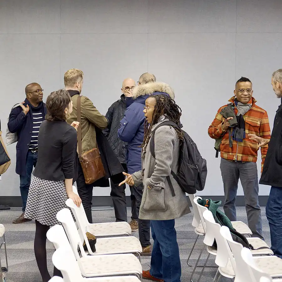 People talking after an event at the Delaney Symposium