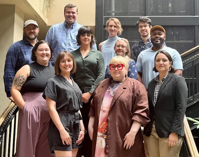 A group of people posing for a photo on steps