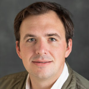 Headshot of a white man with short brown hair