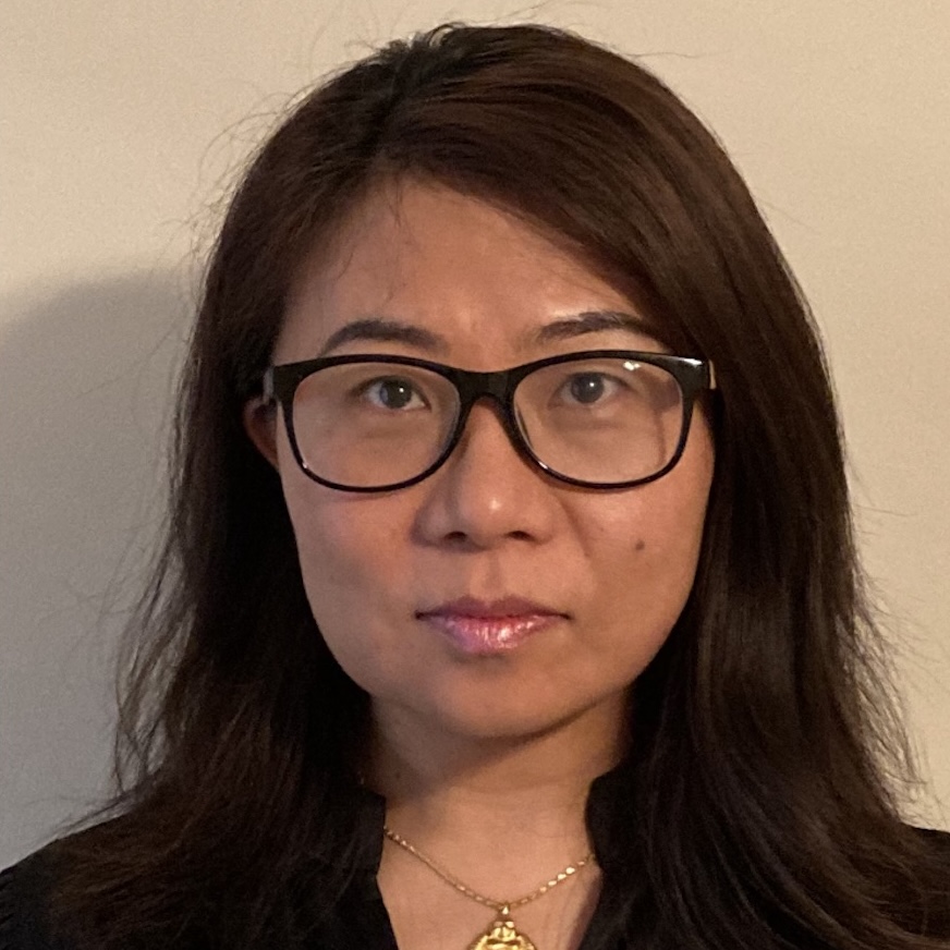 Headshot of an east Asian woman with long hair and glasses.